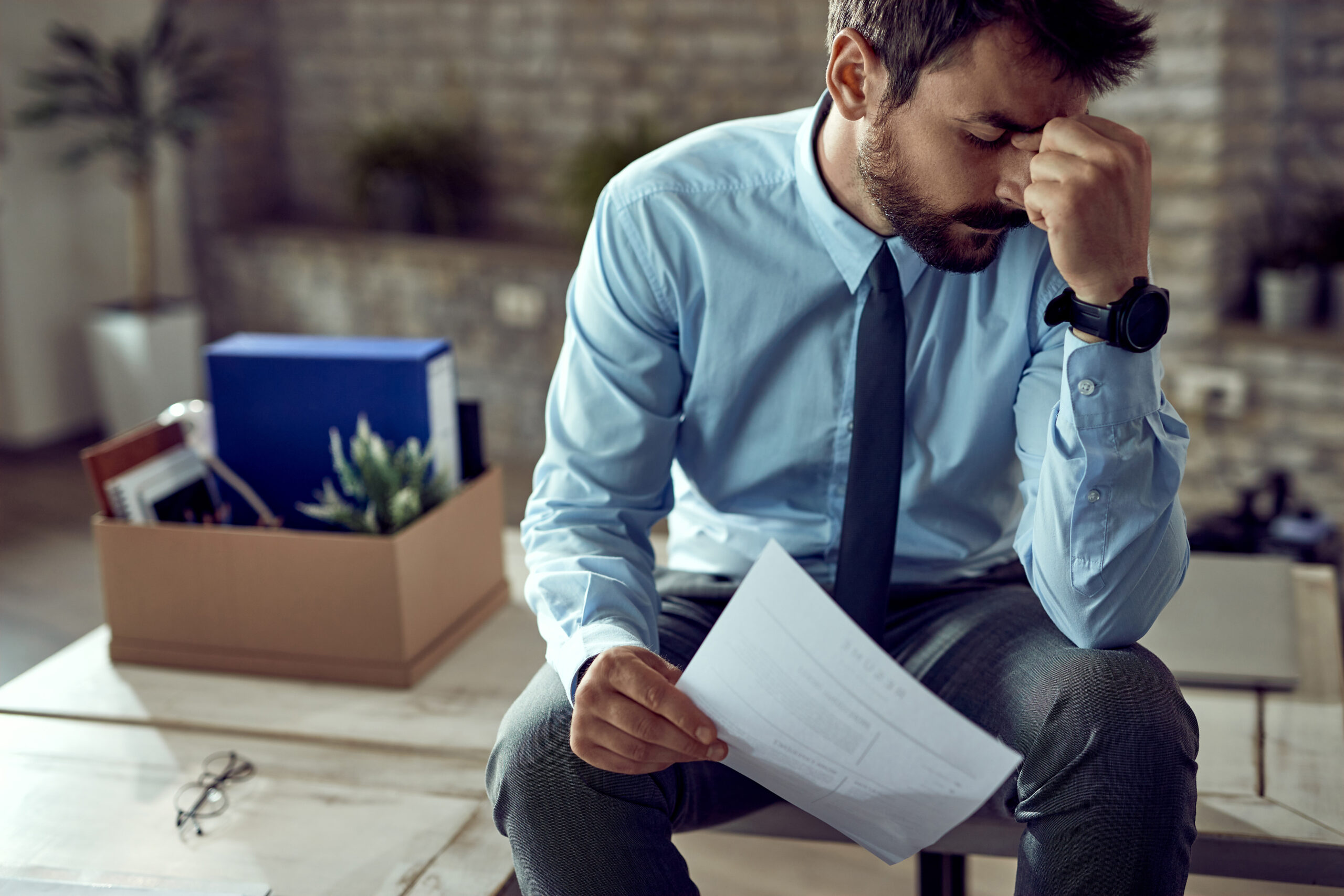 A stressed landlord: Exhausted property owner burdened by rental management issues, feeling overwhelmed with landlord responsibilities